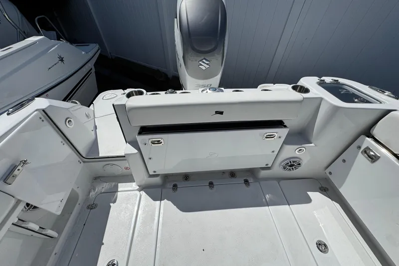 Slide: The Image of 2026 Stingray 259 DC boat interior with seating, storage, and Suzuki engine. - 11