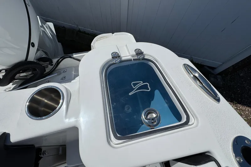 Slide: The Image of 2026 Stingray 259 DC boat detail with sleek design and stainless steel cup holders. - 12