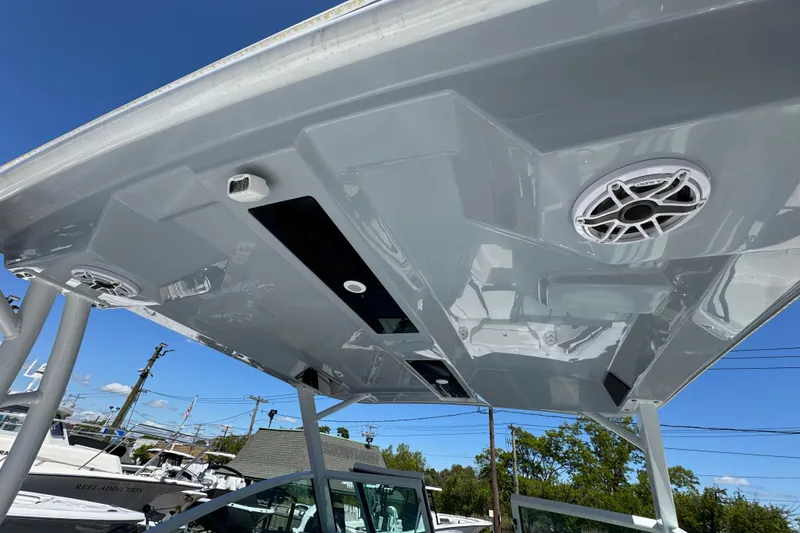Slide: The Image of 2026 Stingray 259 DC boat roof with speakers and sleek design under clear blue sky. - 15