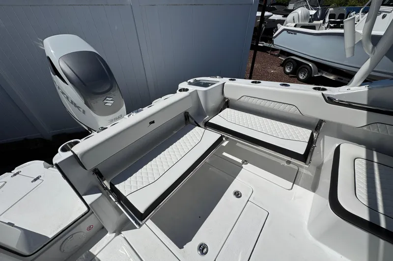 Slide: The Image of 2026 Stingray 259 DC boat interior with Suzuki 350 engine, featuring white seating and sleek design. - 16
