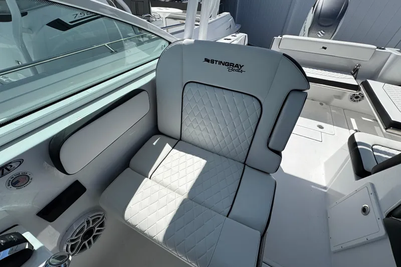 Slide: The Image of 2026 Stingray 259 DC boat interior with quilted seating and modern design. - 23