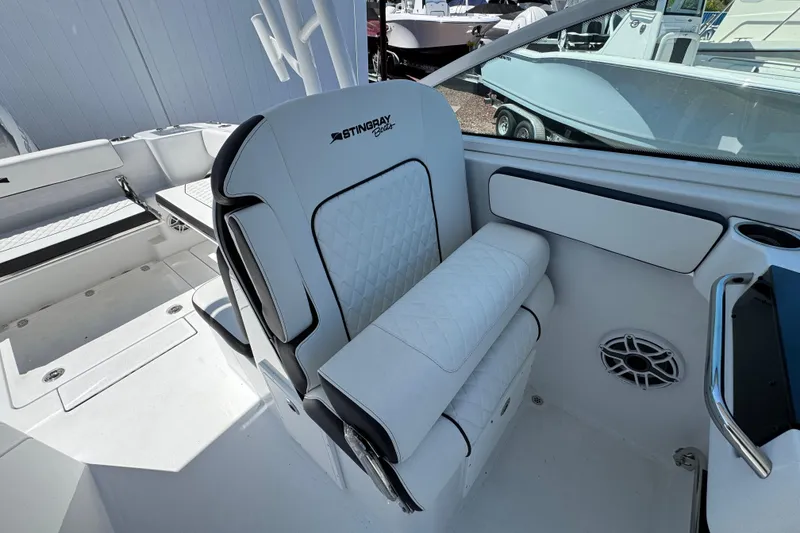 Slide: The Image of 2026 Stingray 259 DC boat interior with white seating and modern design. - 24