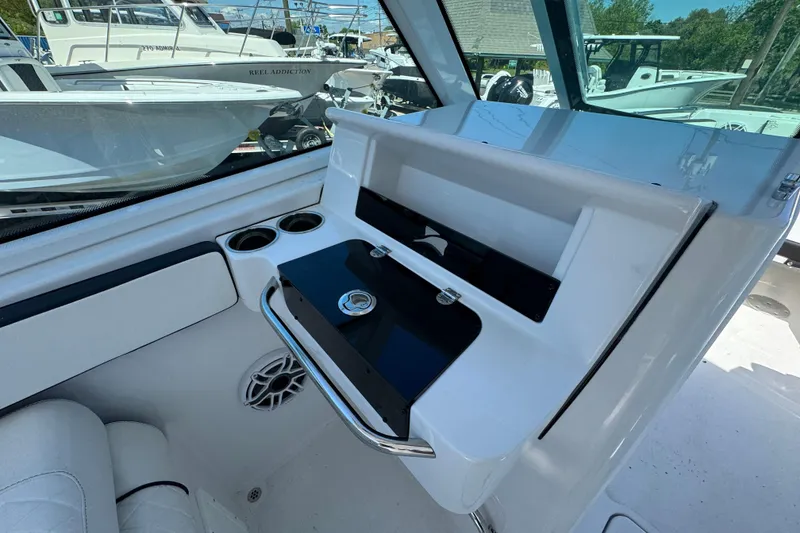 Slide: The Image of Interior view of 2026 Stingray 259 DC boat with sleek dashboard and cup holders. - 25