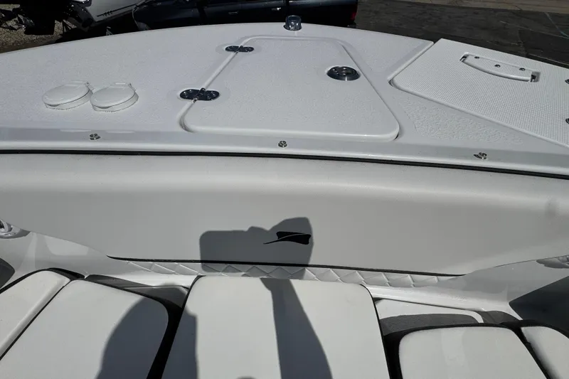 Slide: The Image of 2026 Stingray 259 DC boat interior, featuring sleek white seating and deck details. - 32