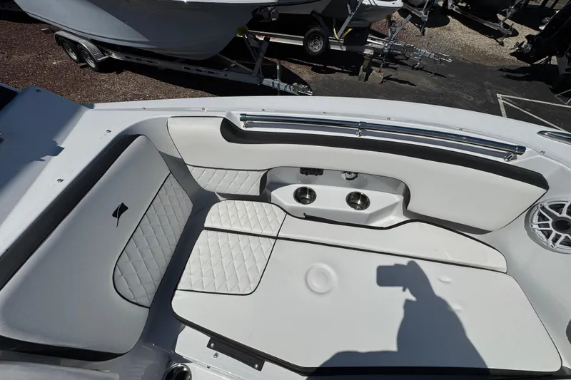 Slide: The Image of 2026 Stingray 259 DC boat interior with white cushioned seating and cup holders. - 34