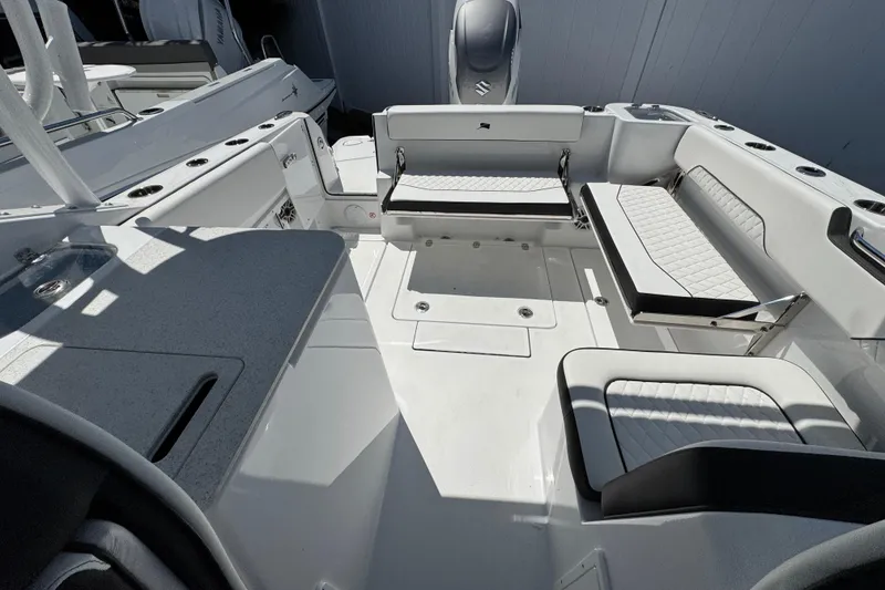 Slide: The Image of 2026 Stingray 259 DC boat interior with white seating and modern design. - 39