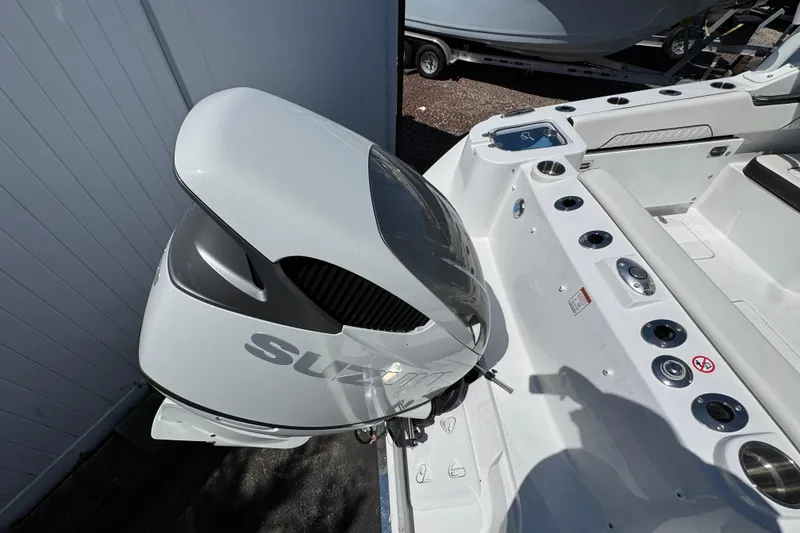 Slide: The Image of 2026 Stingray 259 DC boat with Suzuki outboard motor, featuring sleek white design. - 4