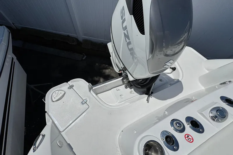Slide: The Image of 2026 Stingray 259 DC boat with Suzuki outboard motor, featuring sleek white deck design. - 41
