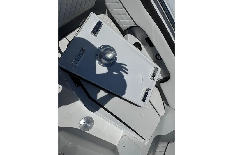 Slide: The Image of Interior of 2026 Stingray 259 DC boat with storage compartment and shadow. - 42