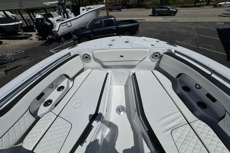 Slide: The Image of 2026 Stingray 259 DC boat interior with white seating and cup holders. - 43