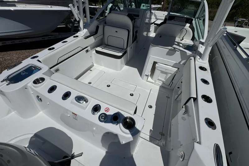 Slide: The Image of 2026 Stingray 259 DC boat interior with seating, storage, and fishing rod holders. - 5