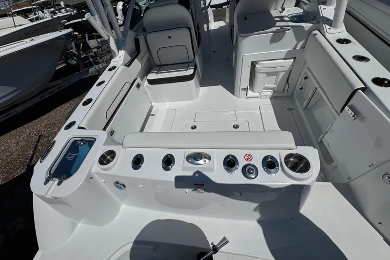 Slide: The Image of 2026 Stingray 259 DC boat interior with seating, cup holders, and storage compartments. - 6