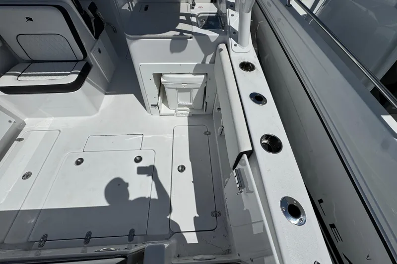 Slide: The Image of 2026 Stingray 259 DC boat interior with seating, storage, and rod holders. - 7