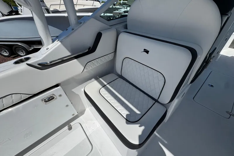 Slide: The Image of 2026 Stingray 259 DC boat interior with white cushioned seating and sleek design. - 9