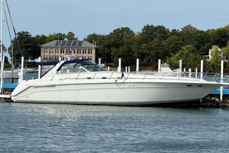 The Image of 1998 Sea Ray 500 Sundancer yacht docked at marina with scenic background. - 0