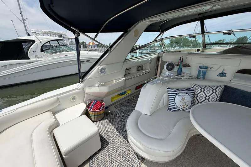 Slide: The Image of Interior of a 1998 Sea Ray 500 Sundancer yacht with cozy seating and nautical decor. - 16