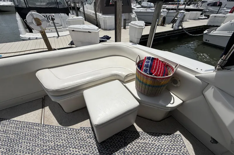 Slide: The Image of Cozy seating area on a 1998 Sea Ray 500 Sundancer yacht with a colorful basket. - 17
