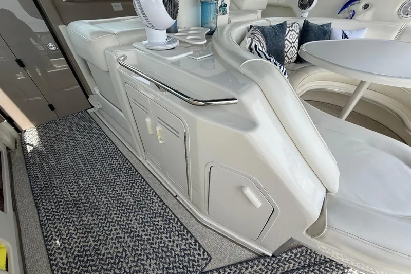Slide: The Image of Interior of a 1998 Sea Ray 500 Sundancer yacht with seating and table. - 20
