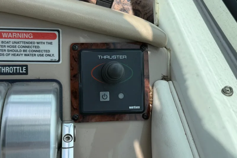 Slide: The Image of Control panel of a 1998 Sea Ray 500 Sundancer with thruster and throttle controls. - 29