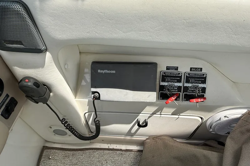 Slide: The Image of Control panel of a 1998 Sea Ray 500 Sundancer boat with Raytheon equipment. - 31