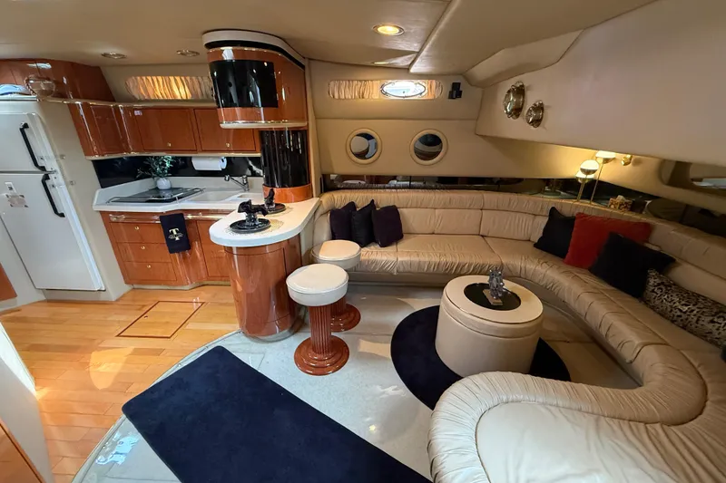 Slide: The Image of Luxurious interior of a 1998 Sea Ray 500 Sundancer yacht with elegant seating and kitchen area. - 39