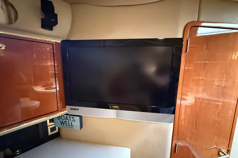 Slide: The Image of Interior of 1998 Sea Ray 500 Sundancer with mounted Vizio TV and wooden cabinetry. - 47