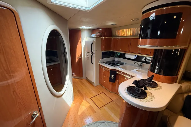 Slide: The Image of Luxurious interior of a 1998 Sea Ray 500 Sundancer yacht with modern kitchen amenities. - 48