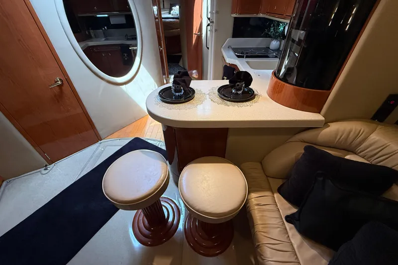 Slide: The Image of Luxurious interior of a 1998 Sea Ray 500 Sundancer yacht with elegant seating and dining area. - 50