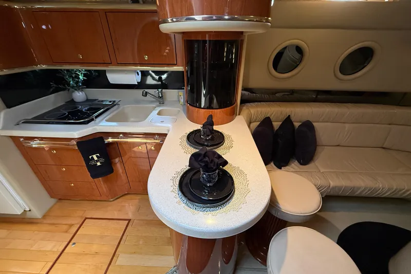 Slide: The Image of Luxurious 1998 Sea Ray 500 Sundancer interior with elegant kitchen and cozy seating area. - 51