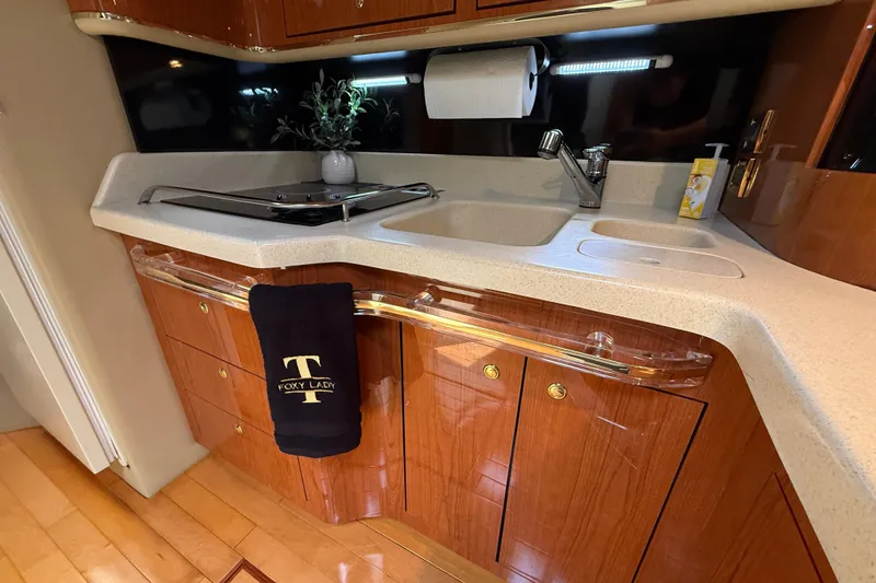 Slide: The Image of Luxurious kitchen area in a 1998 Sea Ray 500 Sundancer yacht with wooden cabinetry. - 55