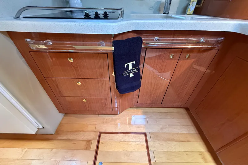 Slide: The Image of 1998 Sea Ray 500 Sundancer kitchen with wooden cabinets and modern appliances. - 58