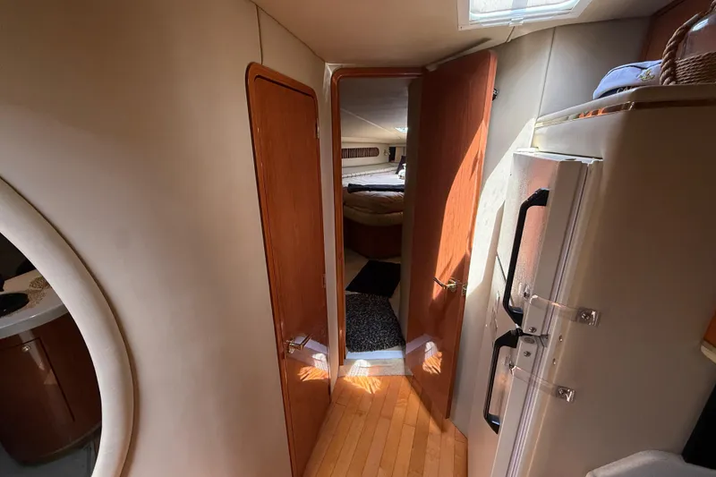 Slide: The Image of Interior view of 1998 Sea Ray 500 Sundancer yacht, featuring wooden flooring and cozy cabin. - 63