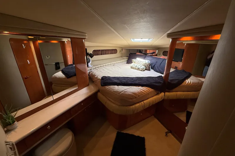 Slide: The Image of Luxurious cabin interior of a 1998 Sea Ray 500 Sundancer yacht with cozy bedding. - 64