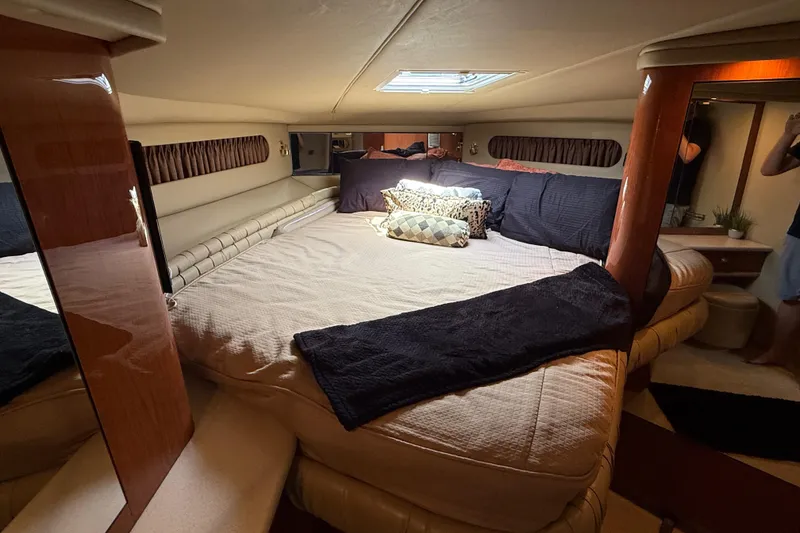 Slide: The Image of Luxurious bedroom interior of 1998 Sea Ray 500 Sundancer yacht with plush bedding. - 65