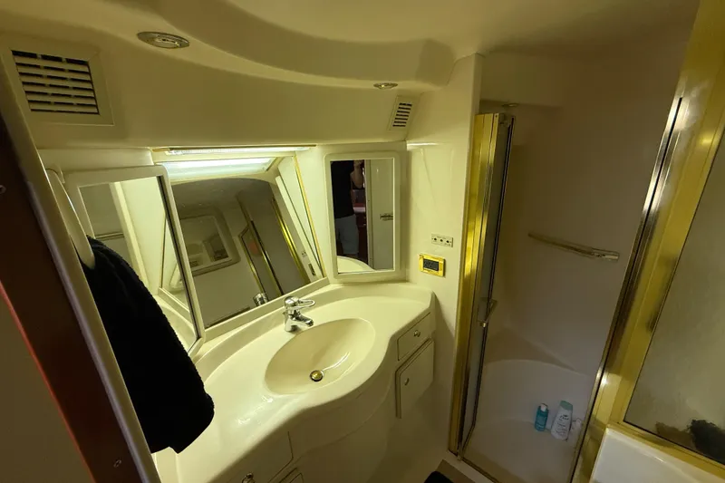 Slide: The Image of 1998 Sea Ray 500 Sundancer bathroom with sink, mirror, and shower enclosure. - 69