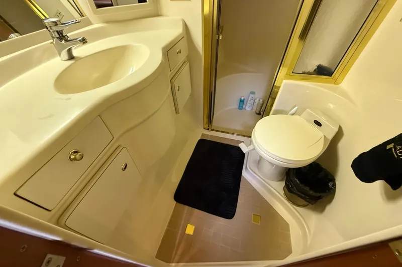 Slide: The Image of Bathroom interior of 1998 Sea Ray 500 Sundancer yacht, featuring sink, toilet, and shower. - 70