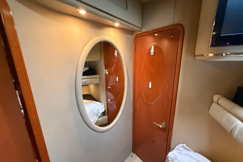 Slide: The Image of Interior cabin of 1998 Sea Ray 500 Sundancer yacht with mirror and wooden door. - 76
