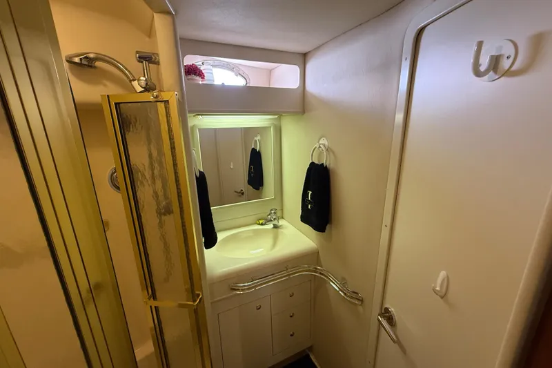 Slide: The Image of Bathroom interior of 1998 Sea Ray 500 Sundancer yacht, featuring shower and sink. - 77