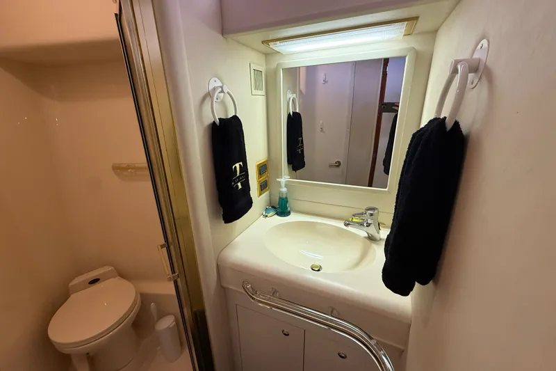 Slide: The Image of Bathroom interior of 1998 Sea Ray 500 Sundancer yacht, featuring sink, mirror, and toilet. - 78