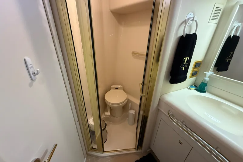Slide: The Image of Bathroom interior of 1998 Sea Ray 500 Sundancer yacht, featuring shower and sink. - 79