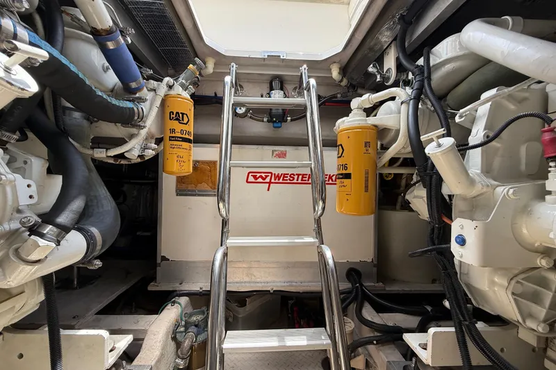 Slide: The Image of Engine room of a 1998 Sea Ray 500 Sundancer with CAT filters and ladder access. - 83