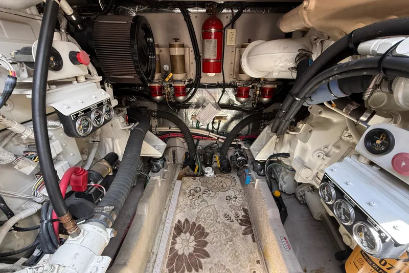 Slide: The Image of Engine room of a 1998 Sea Ray 500 Sundancer, showcasing mechanical components and gauges. - 84