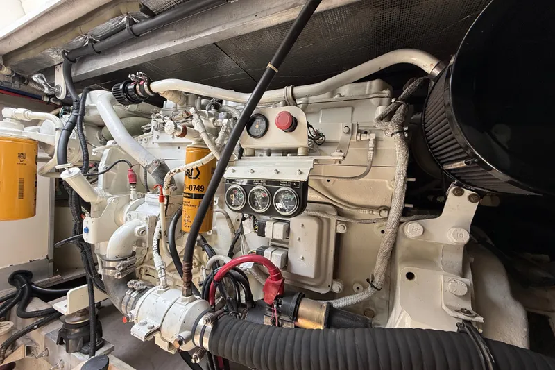 Slide: The Image of Engine compartment of a 1998 Sea Ray 500 Sundancer, showcasing detailed mechanical components. - 85