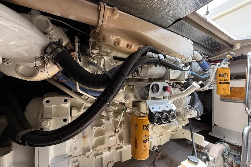 Slide: The Image of Engine room of a 1998 Sea Ray 500 Sundancer with visible CAT filters and components. - 86