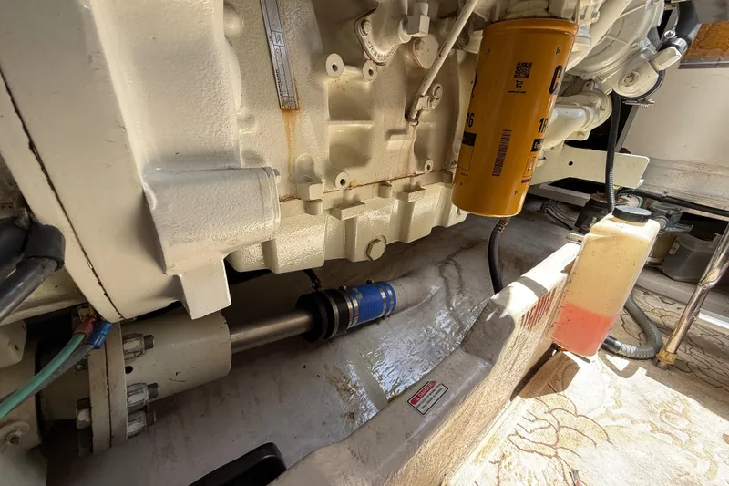 Slide: The Image of Engine compartment of a 1998 Sea Ray 500 Sundancer, showcasing mechanical components and filters. - 88