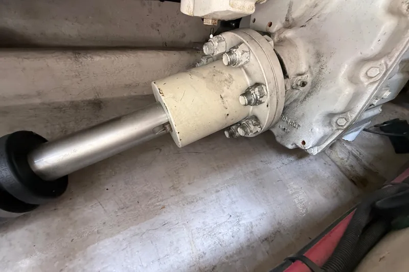 Slide: The Image of Engine component of a 1998 Sea Ray 500 Sundancer boat, showing shaft and bolts. - 90