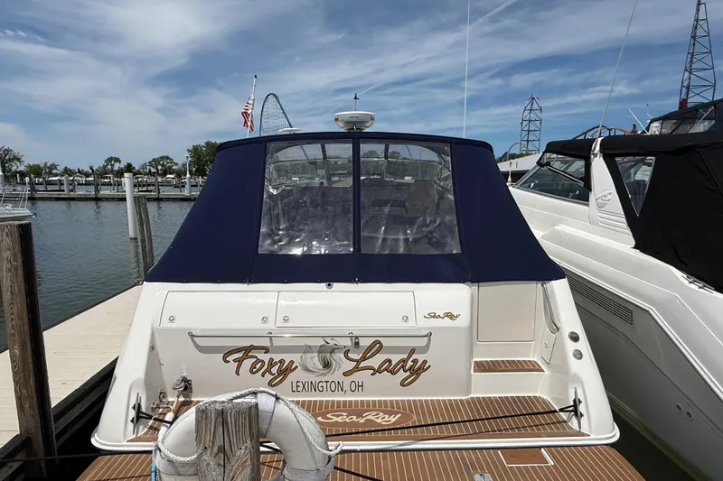 Slide: The Image of 1998 Sea Ray 500 Sundancer yacht on stands, featuring a sleek white hull and blue canopy. - 97