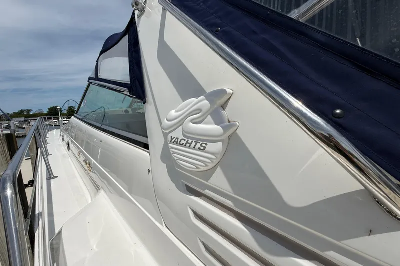 Slide: The Image of 1998 Sea Ray 500 Sundancer yacht on land, showcasing sleek design and spacious deck. - 98