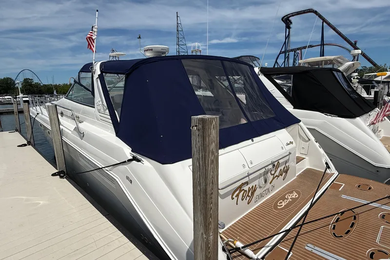Slide: The Image of 1998 Sea Ray 500 Sundancer yacht on dry dock, side view with overcast sky. - 99