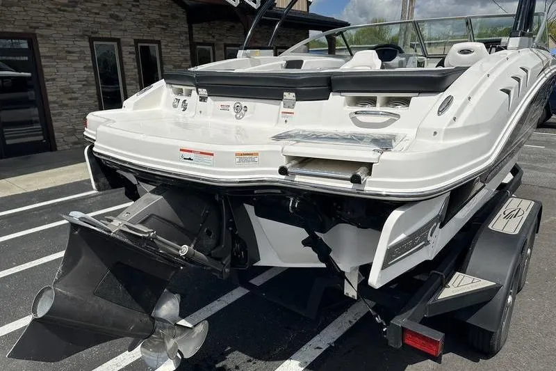 Slide: The Image of 2021 Chaparral 21 Surf boat rear view, showcasing propeller and sleek design. - 10